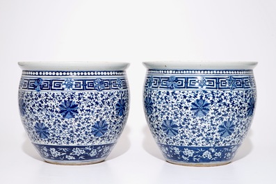 A pair of Chinese blue and white lotus scroll fishbowls, 19th C.