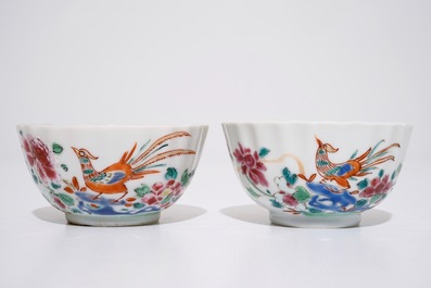 A pair of Chinese famille rose cups and saucers with peacocks, Qianlong
