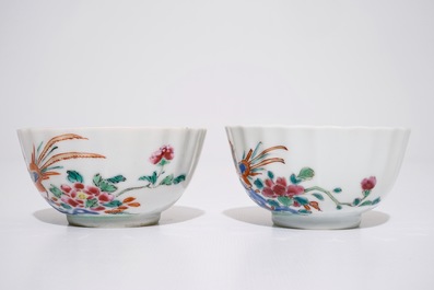 A pair of Chinese famille rose cups and saucers with peacocks, Qianlong