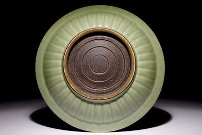 A Chinese celadon dish with incised lotus design, 19th C.