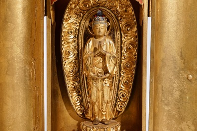A Japanese lacquered and gilt wood "Zushi" shrine with a standing Buddha on a lotus throne, Edo, 17/18th C.
