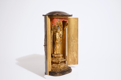 A Japanese lacquered and gilt wood "Zushi" shrine with a standing Buddha on a lotus throne, Edo, 17/18th C.