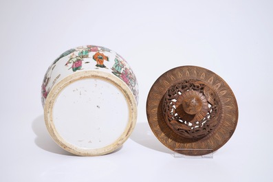 A Chinese famille rose warriors jar with wooden cover, 19th C.