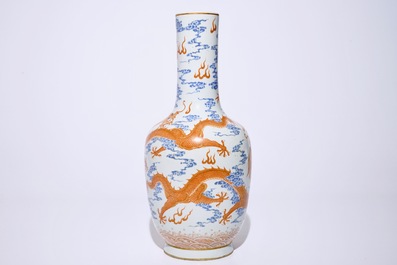 A Chinese iron red and overglaze blue vase with dragons among clouds, 19/20th C.