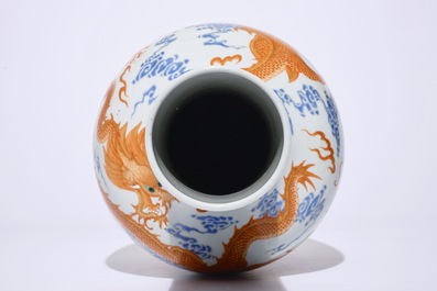 A Chinese iron red and overglaze blue vase with dragons among clouds, 19/20th C.