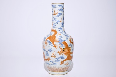A Chinese iron red and overglaze blue vase with dragons among clouds, 19/20th C.