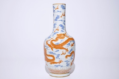 A Chinese iron red and overglaze blue vase with dragons among clouds, 19/20th C.