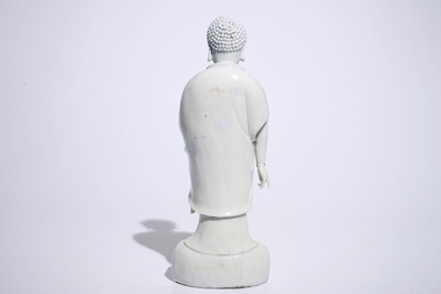A Chinese Dehua blanc de Chine model of a standing Buddha, impressed mark on the back, Kangxi