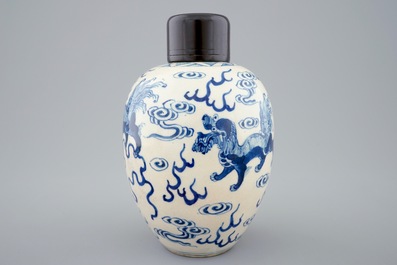 A Chinese blue and white soft paste jar with wooden cover, 19th C.