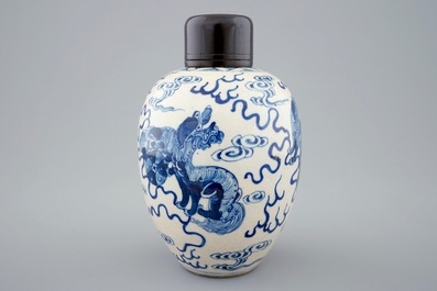 A Chinese blue and white soft paste jar with wooden cover, 19th C.