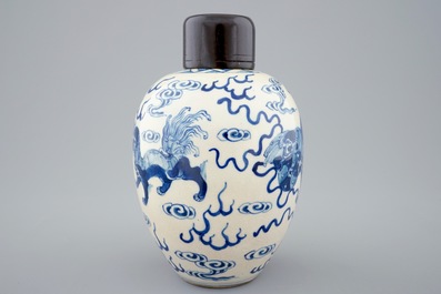 A Chinese blue and white soft paste jar with wooden cover, 19th C.