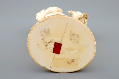A Japanese ivory okimono of a chicken farmer, Meiji, 19th C., signed