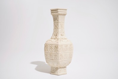 A Chinese white-glazed relief-decorated vase with text bands, 19th C.