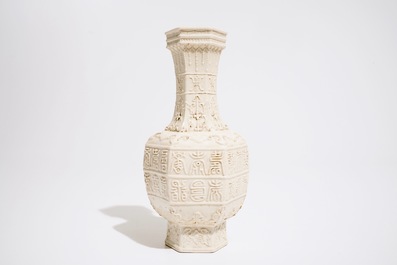 A Chinese white-glazed relief-decorated vase with text bands, 19th C.