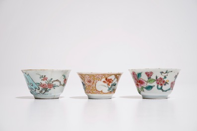Three Chinese famille rose cups and two saucers, Yongzheng/Qianlong