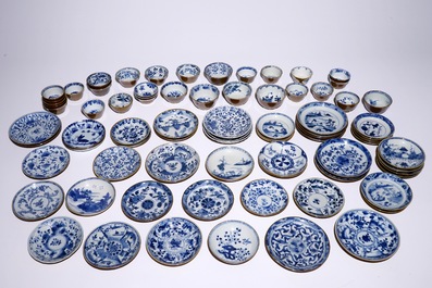 A large collection of Chinese blue and white on capucin brown ground cups and saucers, Kangxi/Qianlong