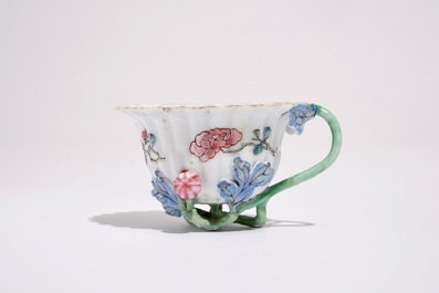 A Chinese famille rose lotus-shaped relief-decorated cup and saucer, Yongzheng