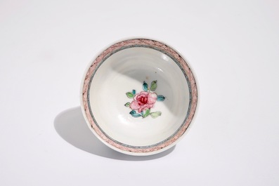 A Chinese famille rose cup and saucer with a lady and a boy, Yongzheng