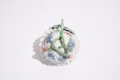 A Chinese famille rose lotus-shaped relief-decorated cup and saucer, Yongzheng