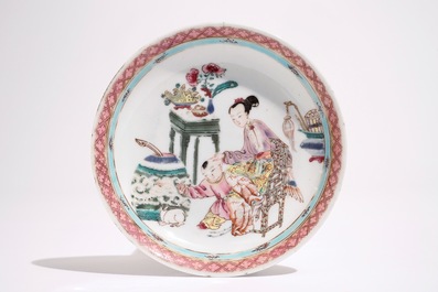 A Chinese famille rose cup and saucer with a lady and a boy, Yongzheng