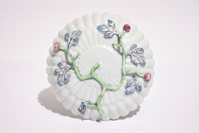 A Chinese famille rose lotus-shaped relief-decorated cup and saucer, Yongzheng