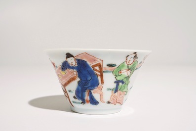 A Chinese famille rose cup and saucer with a tea-drinking scene, Yongzheng