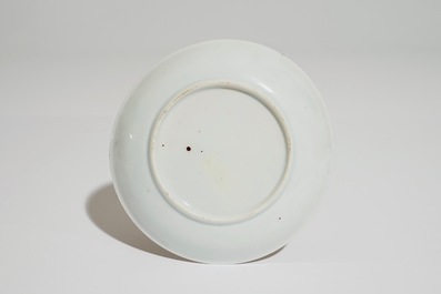 A Chinese famille rose cup and saucer with a tea-drinking scene, Yongzheng