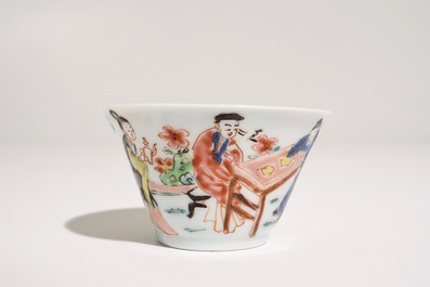 A Chinese famille rose cup and saucer with a tea-drinking scene, Yongzheng
