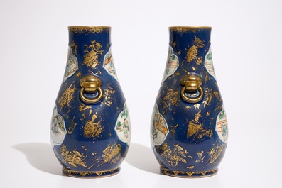 A pair of Chinese famille verte on powder blue and gilt ground vases, 19th C.