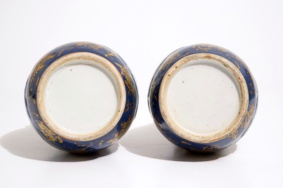 A pair of Chinese famille verte on powder blue and gilt ground vases, 19th C.