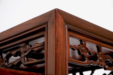 A set of four Chinese sculpted hardwood stacking tables, 20th C.