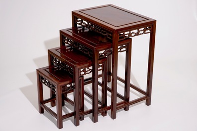 A set of four Chinese sculpted hardwood stacking tables, 20th C.