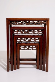 A set of four Chinese sculpted hardwood stacking tables, 20th C.