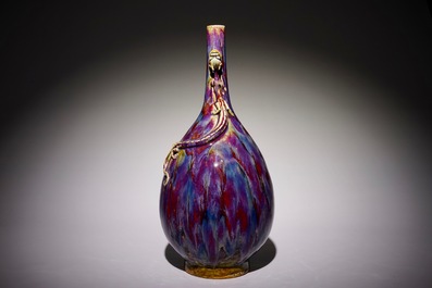 A Chinese monochrome flambe-glazed bottle vase with dragon handles, 19th C.