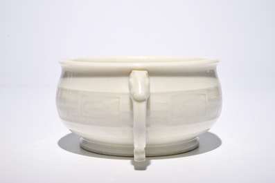 A round Chinese Dehua blanc de Chine censer with moulded and underglaze decoration, 19th C.