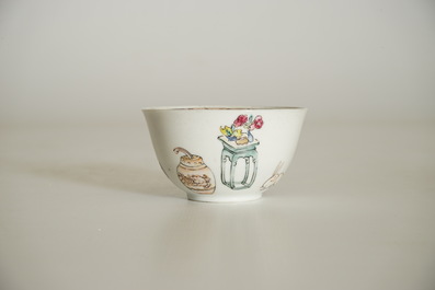 A Chinese famille rose cup and saucer with a lady and a boy, Yongzheng
