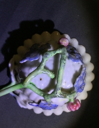 A Chinese famille rose lotus-shaped relief-decorated cup and saucer, Yongzheng