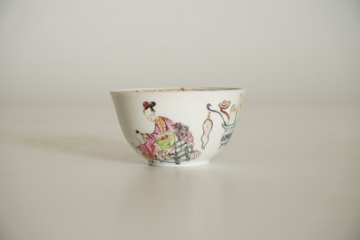 A Chinese famille rose cup and saucer with a lady and a boy, Yongzheng