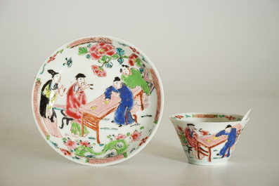 A Chinese famille rose cup and saucer with a tea-drinking scene, Yongzheng