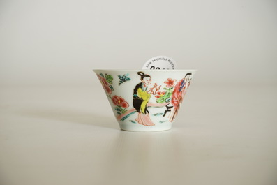 A Chinese famille rose cup and saucer with a tea-drinking scene, Yongzheng