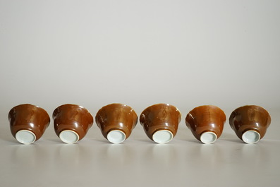 Six Chinese blue and white on capucin brown ground cups and saucers, Kangxi