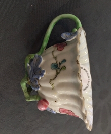 A Chinese famille rose lotus-shaped relief-decorated cup and saucer, Yongzheng