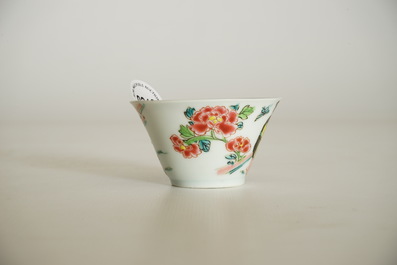 A Chinese famille rose cup and saucer with a tea-drinking scene, Yongzheng