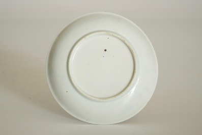 A Chinese famille rose cup and saucer with a tea-drinking scene, Yongzheng