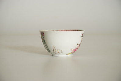 A Chinese famille rose cup and saucer with a lady and a boy, Yongzheng