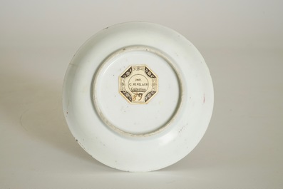 A Chinese famille rose cup and saucer with a lady and a boy, Yongzheng