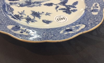 A pair of Chinese blue and white plates with animals in a garden, Qianlong