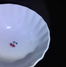 A pair of Chinese famille rose cups and saucers with peacocks, Qianlong