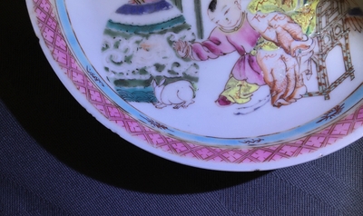 A Chinese famille rose cup and saucer with a lady and a boy, Yongzheng
