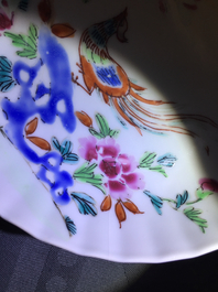 A pair of Chinese famille rose cups and saucers with peacocks, Qianlong